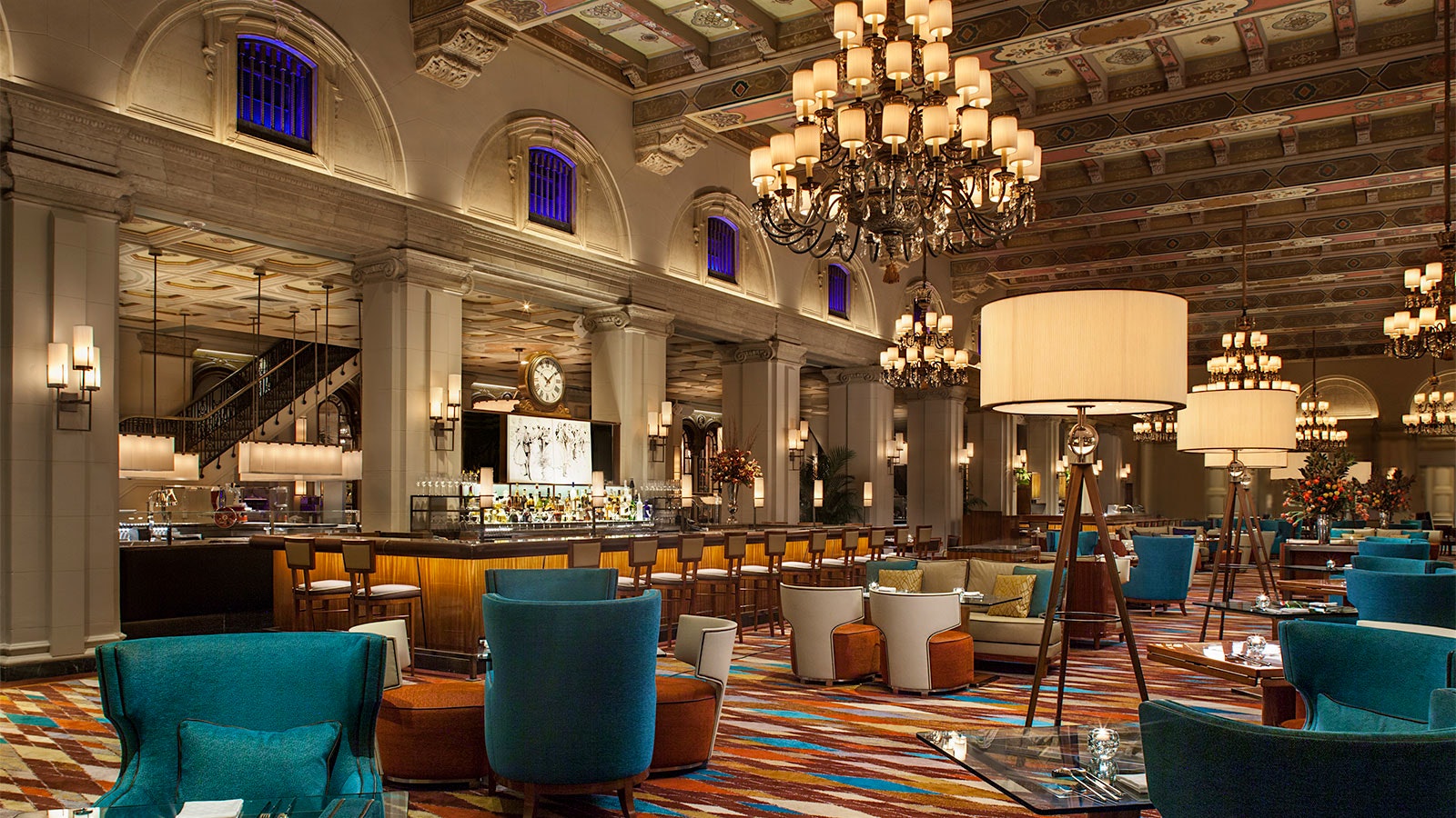 The lounge at the Breakers Palm Beach, with blue chairs and a coffered ceiling